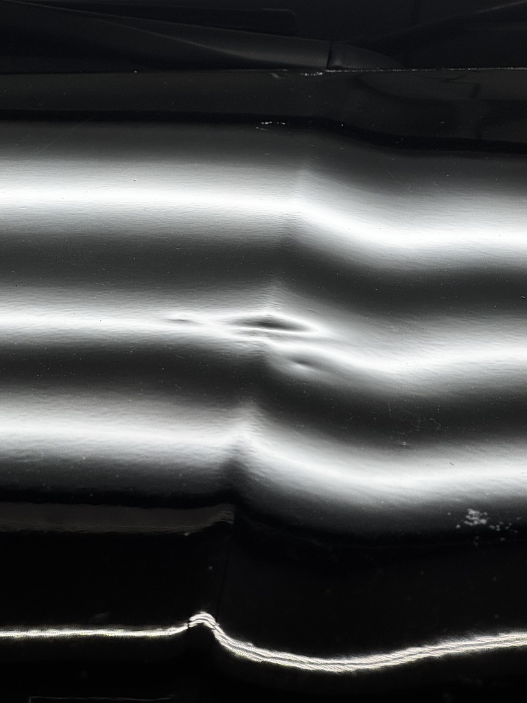 Cluster of small dents visible in reflected light