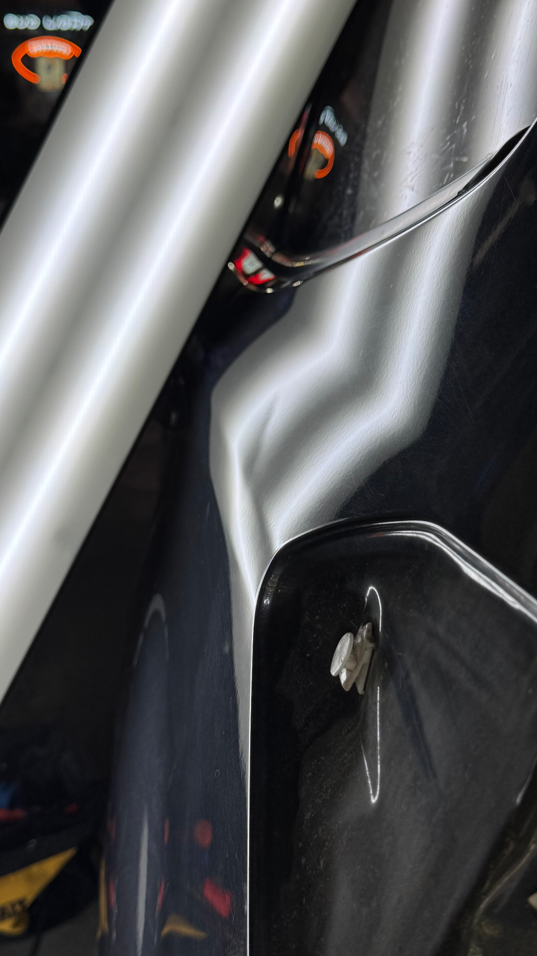 Deep vehicle panel dent revealed by a PDR reflection light